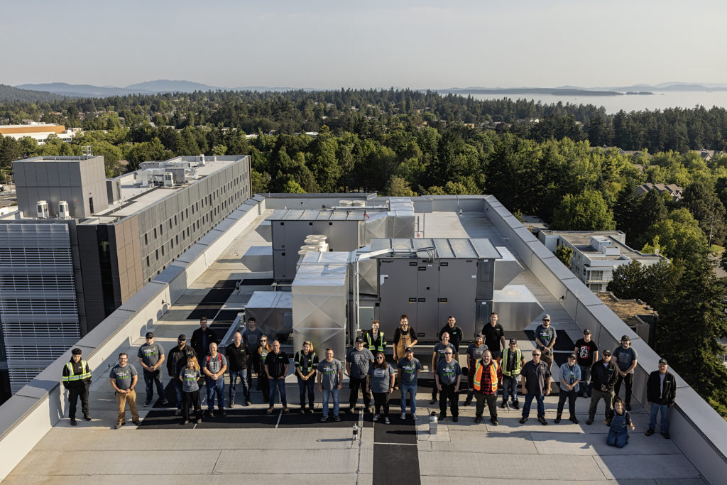 LSM team atop UVic building two upon completion